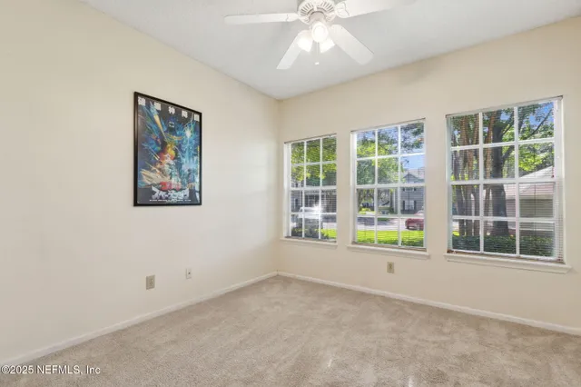 a view of livingroom with flat screen tv and window