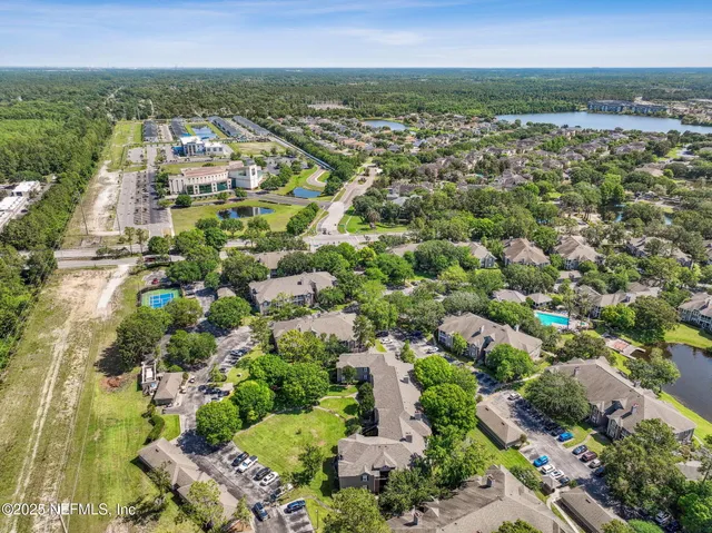 a view of a swimming pool with a patio and a yard