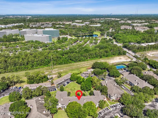 a view of a chairs and table in the patio with a lake view