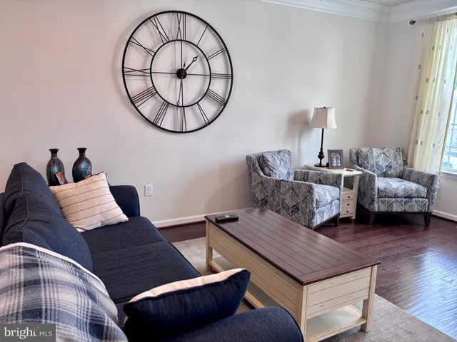 a living room with furniture a mirror and a window