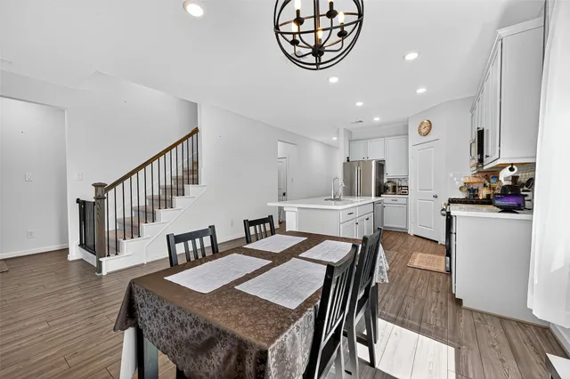 a view of a dining room with furniture wooden floor and kitchen