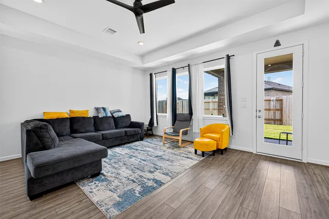 a living room with furniture and wooden floor