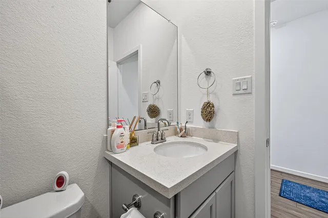 a bathroom with a sink vanity and a mirror