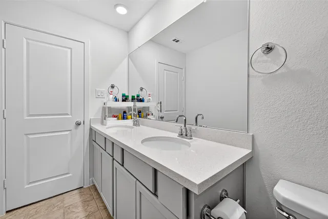 a bathroom with a sink vanity and a mirror