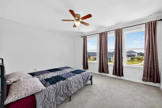 a bedroom with a large bed and a large window