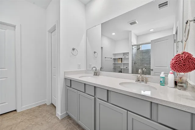a bathroom with a sink double vanity and a mirror