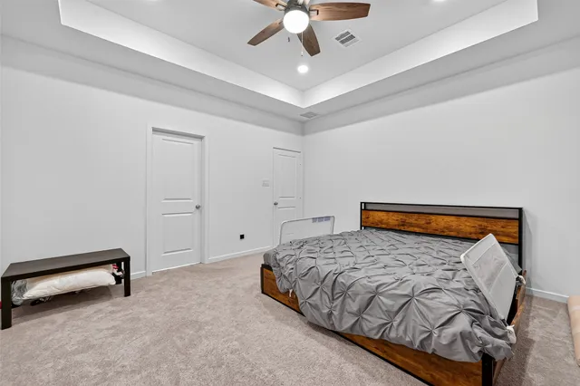a bedroom with a bed and a ceiling fan