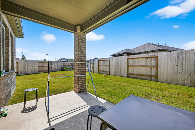 a view of a backyard with wooden fence