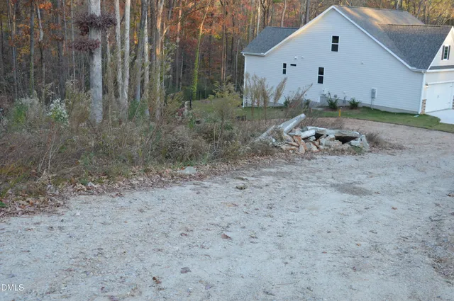 a view of a house with backyard and trees
