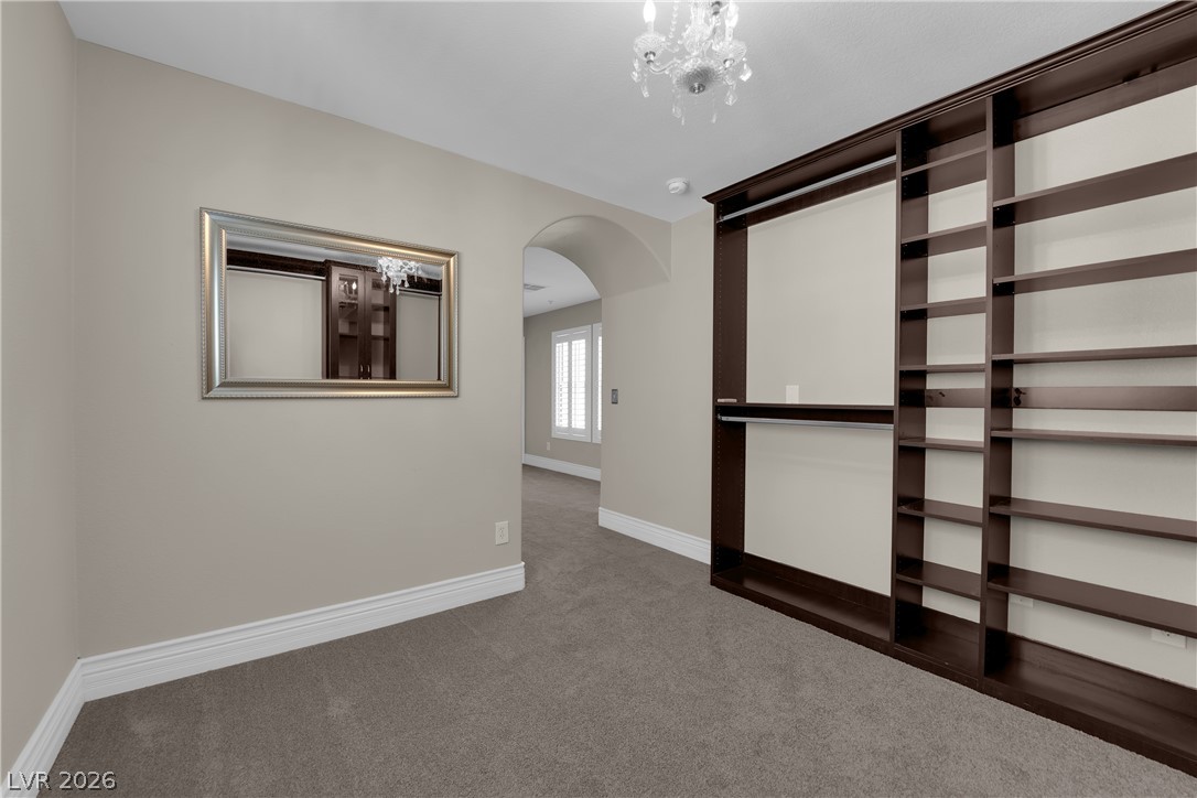 646 Monument Point Street Henderson, NV 89002 - Photo 25 of 44 Custom built-ins and plush carpeting create a spacious dressing area.