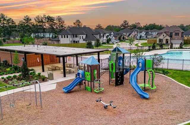 a view of a park with swings and slides