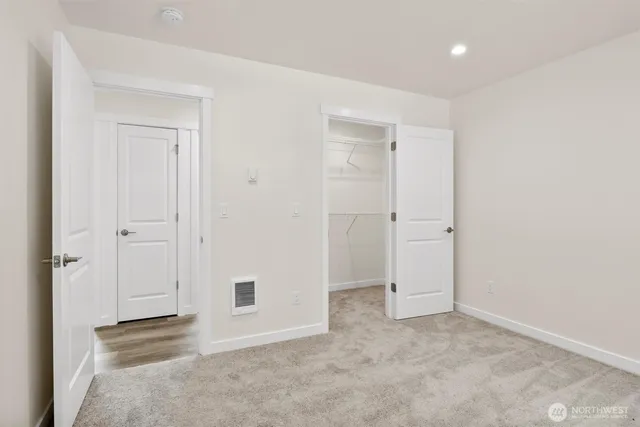 an empty room with closet area