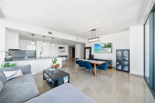 a living room with furniture a rug and a chandelier