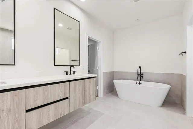 a bathroom with a double vanity sink and mirror