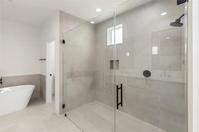 a bathroom with a bathtub and shower
