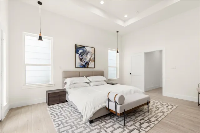 a bedroom with a large bed and a window