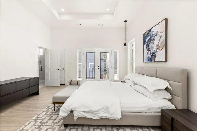 a bedroom with a bed and a painting on the wall