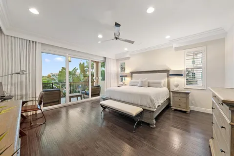 a bed sitting in a spacious bedroom next to a window