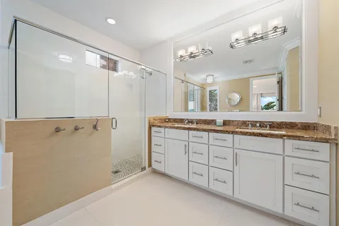 a bathroom with a granite countertop sink mirror and a