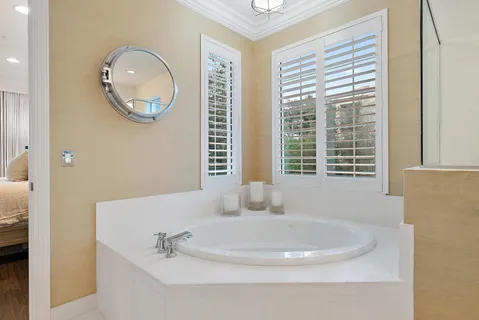 a bathroom with a sink a window and a mirror