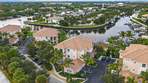 an aerial view of a house with a yard and lake view