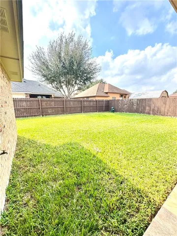 a view of a house with a yard and sitting area