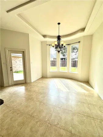 a view of an empty room with a chandelier