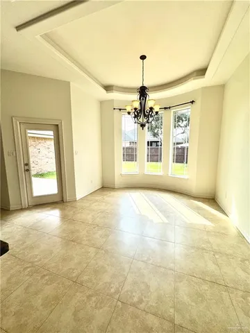 a view of an empty room with a chandelier