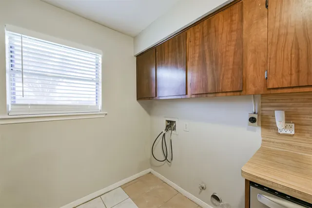 a bathroom with a granite countertop sink and cabinets