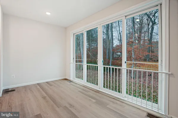 a view of a room with wooden floor and a window