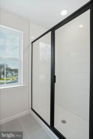a bathroom with a glass shower door