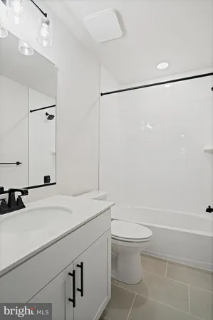 a bathroom with a sink a toilet and a shower
