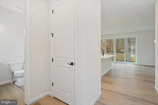 a view of a bathroom from the hallway with toilet