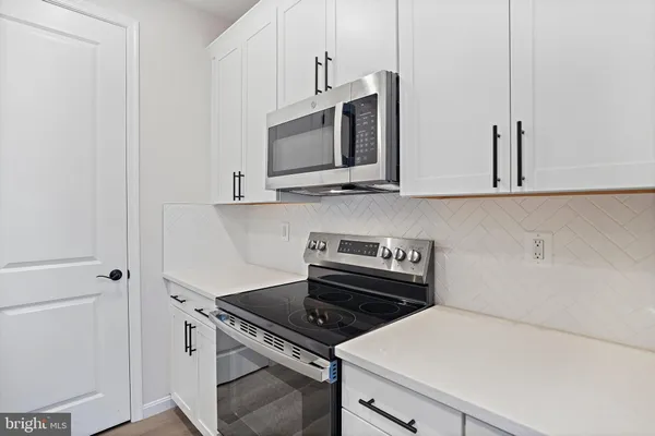 a kitchen with a stove and a microwave