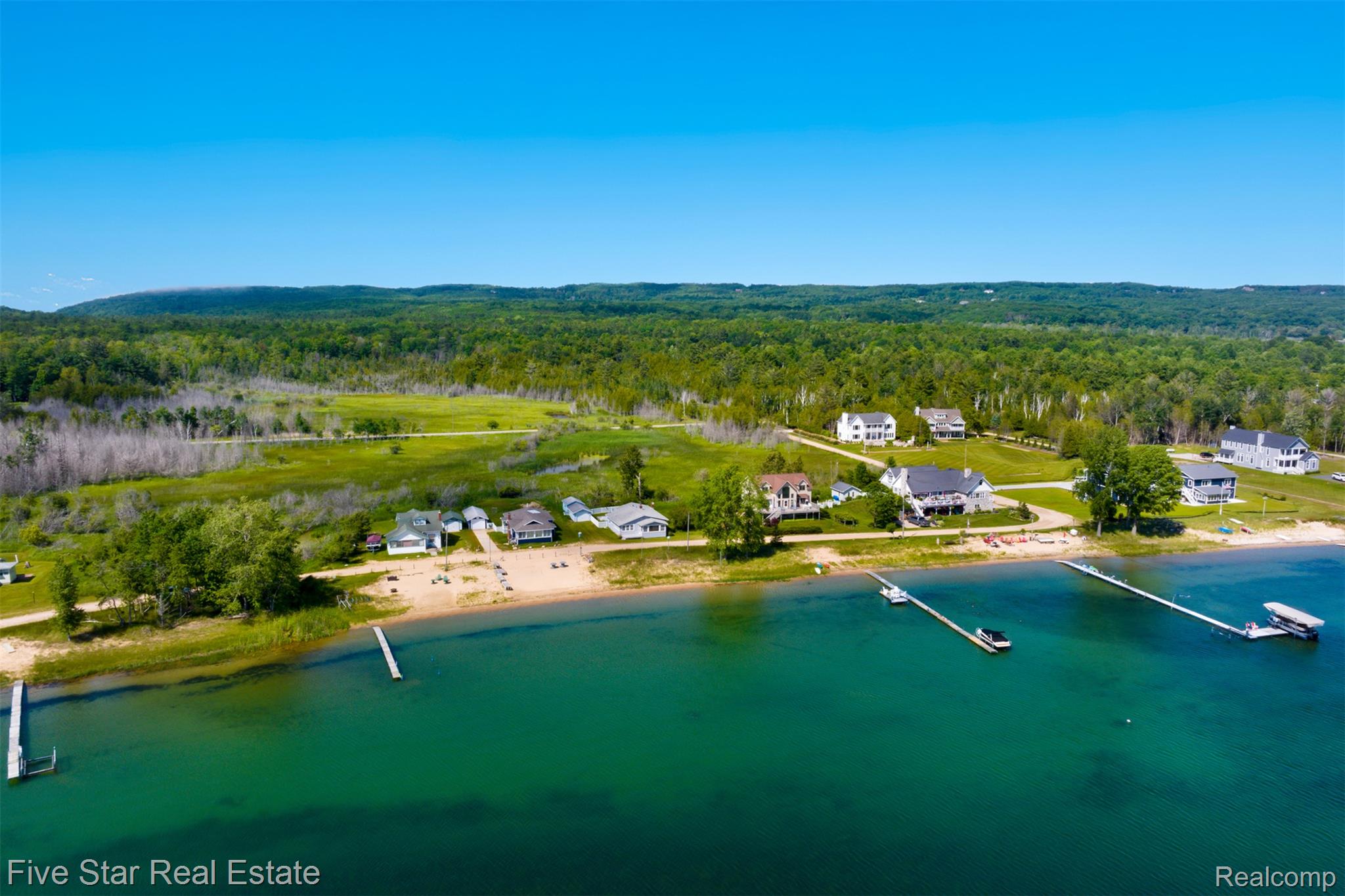 2588 Lakeview Road Onekama, MI 49675 - Photo 4 of 32 Expansive waterfront properties featuring sandy beaches, multiple private docks, and lush green surroundings