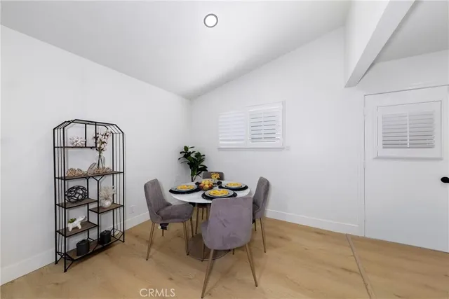 a view of a kitchen with kitchen island a sink wooden floor and a counter top space