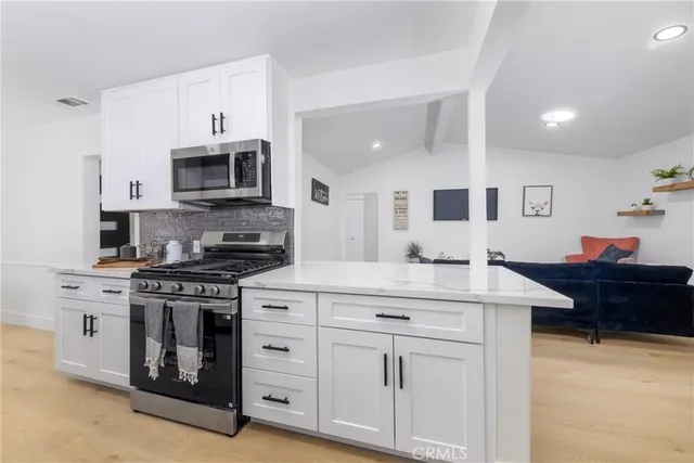 a kitchen with white cabinets and a sink
