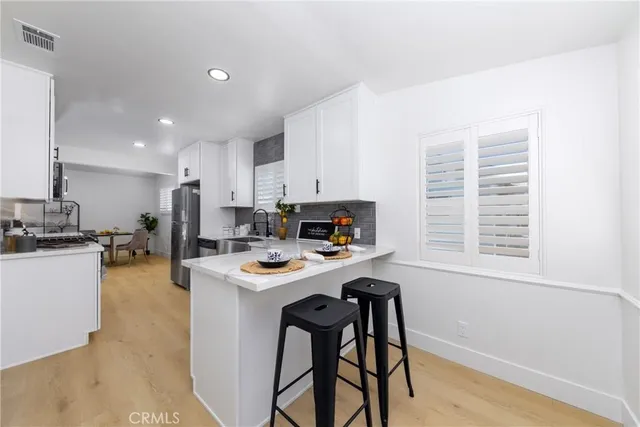a dining room with furniture and a flat screen tv