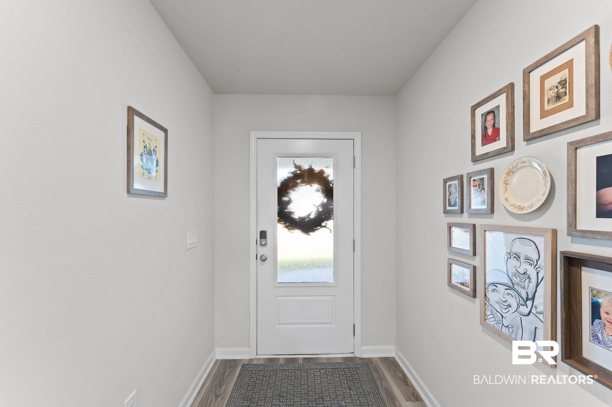 24337 Ringneck Loop Elberta, AL 36530 - Photo 4 of 34 Doorway to outside with baseboards and wood finished floors