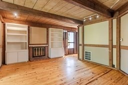 53 Pine Grove, Unit 53 Amherst, MA 01002 - Photo 11 of 34 a view of a hallway with wooden floor and a room