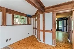 a view of a hallway with a window and wooden floor
