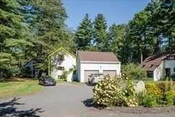 a front view of a house with a yard and a garage