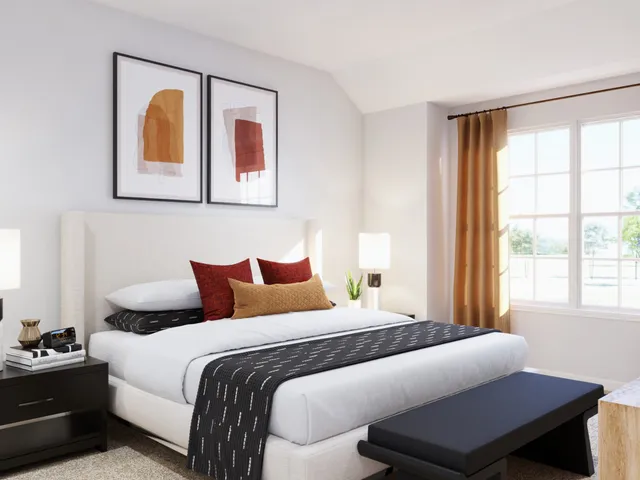 a bedroom with a bed and a potted plant