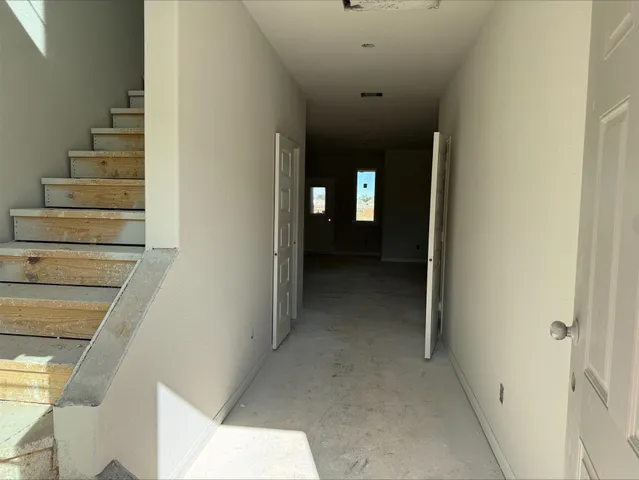 a view of a hallway with stairs