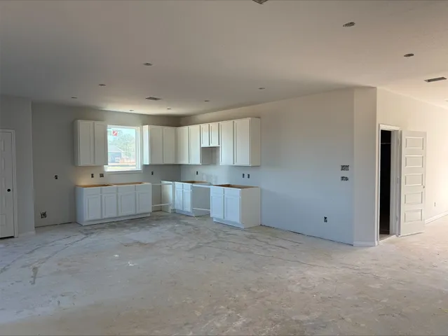 a view of a kitchen with wooden cabinet and a sink
