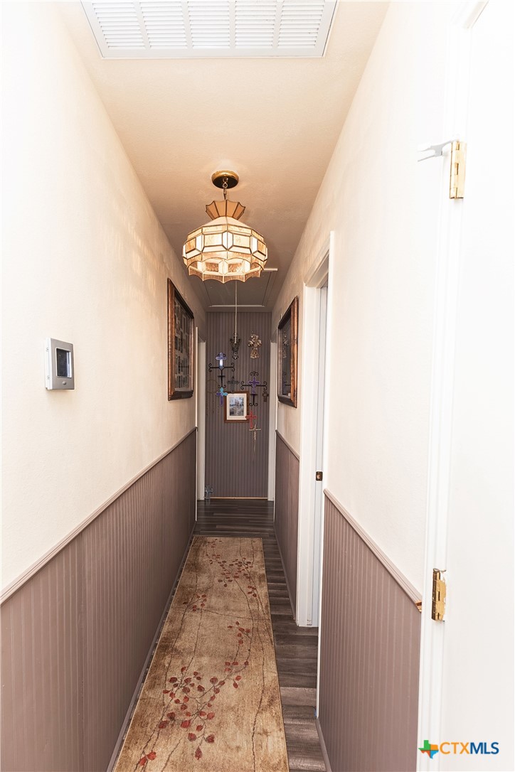 802 Bay Street Austwell, TX 77950 - Photo 12 of 27 a view of a hallway with a dining table and chairs