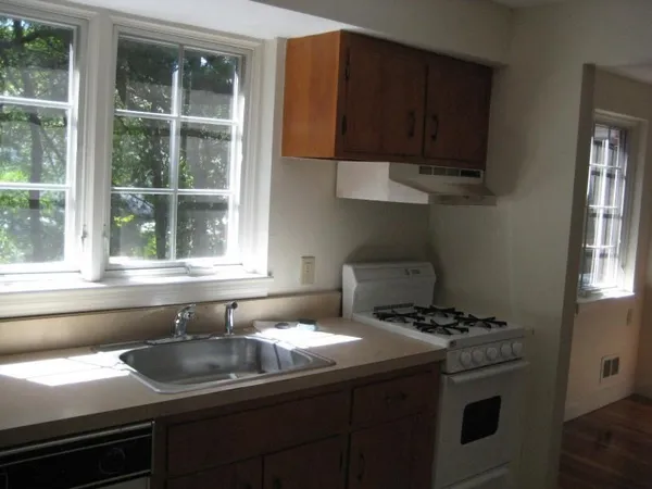 a utility room with wooden floor washer and dryer