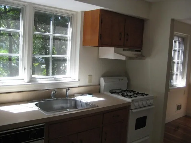 a utility room with wooden floor washer and dryer