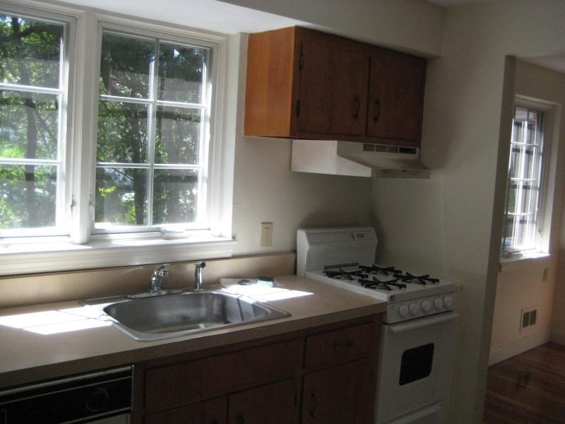 37 Linden Street, Unit 23 Wellesley, MA 02482 - Photo 3 of 9 a kitchen with granite countertop a sink stove and cabinets
