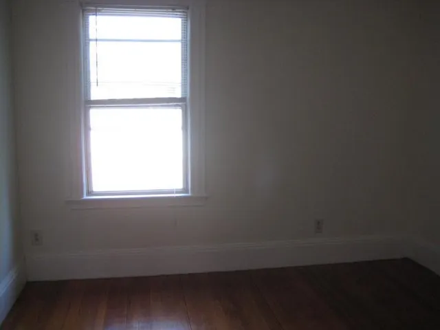 a view of a small space with wooden floor and closet